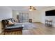 Comfortable living room featuring a sliding glass door, wood floors, and recessed lighting at 8827 N New World Dr, Glendale, AZ 85302