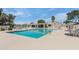 Community pool area with ample seating, shade structures and palm trees at 8827 N New World Dr, Glendale, AZ 85302
