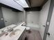 Bathroom featuring a combination tub and shower, white tile surround, and vanity at 9209 N 59Th Ave # 206, Glendale, AZ 85302