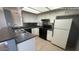 Well-lit kitchen boasts white cabinetry, modern appliances, and a functional layout at 9209 N 59Th Ave # 206, Glendale, AZ 85302