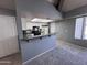 Living room featuring an open floor plan, breakfast bar, and view into the kitchen area at 9209 N 59Th Ave # 206, Glendale, AZ 85302