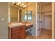 Bathroom featuring double sinks, vanity area, and a glimpse into the walk-in closet at 9843 E Acacia Dr, Scottsdale, AZ 85260