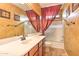 Bathroom featuring double sinks, wood cabinets, and a shower/tub combo at 9843 E Acacia Dr, Scottsdale, AZ 85260