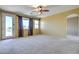 Carpeted bedroom with natural light, balcony access, and neutral walls with dark trim at 9843 E Acacia Dr, Scottsdale, AZ 85260