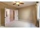 Neutral-toned bedroom with open door, closet, and a carpeted floor at 9843 E Acacia Dr, Scottsdale, AZ 85260