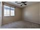 Bedroom with neutral walls, carpeted flooring and a ceiling fan at 9843 E Acacia Dr, Scottsdale, AZ 85260