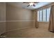 Bedroom featuring neutral walls, carpet flooring, and a window with shutters and drapes at 9843 E Acacia Dr, Scottsdale, AZ 85260