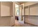 Walk-in closet offering custom shelves and storage, with a view into the bathroom at 9843 E Acacia Dr, Scottsdale, AZ 85260