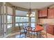 Cozy dining area by a large window offers picturesque views of the pool and the lush backyard at 9843 E Acacia Dr, Scottsdale, AZ 85260