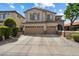 Charming two-story stucco home with a three-car garage, desert landscaping, and a tile roof at 9843 E Acacia Dr, Scottsdale, AZ 85260