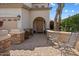 Charming courtyard with stone accents leading to the front entry with seating and desert landscaping at 9843 E Acacia Dr, Scottsdale, AZ 85260