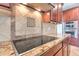 Granite countertops and stainless steel appliances give this kitchen a modern, luxurious feel at 9843 E Acacia Dr, Scottsdale, AZ 85260