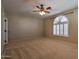 Spacious main bedroom features plush carpet, ceiling fan, and shuttered window at 9843 E Acacia Dr, Scottsdale, AZ 85260