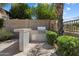 Outdoor kitchen and grilling area with built in barbeque, under counter storage and block privacy wall at 9843 E Acacia Dr, Scottsdale, AZ 85260
