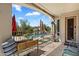 Covered patio with tiled flooring, wrought iron railing overlooking pool, and gas heater for outdoor comfort at 9843 E Acacia Dr, Scottsdale, AZ 85260