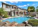 Backyard pool area with lush tropical landscaping, covered patio, and a view of the home's rear facade at 9843 E Acacia Dr, Scottsdale, AZ 85260