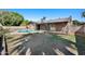 Expansive backyard featuring a refreshing pool, lush greenery, and a covered patio area at , Glendale, AZ 85302