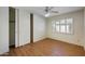 Bedroom featuring wood floors, closet, and shutters for natural lighting at , Glendale, AZ 85302