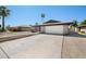 Charming single-story home with a brick exterior and well-maintained front yard and long driveway at , Glendale, AZ 85302