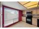 Efficient kitchen with tiled floors, ample cabinets, and a window above the sink at , Glendale, AZ 85302