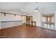 Bright living room with wood floors, ceiling fans, and shelving for a comfortable living space at , Glendale, AZ 85302