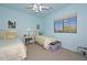 Light blue bedroom featuring two twin beds and a window with natural light at 15953 W Custer Ln, Surprise, AZ 85379