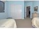 Tranquil bedroom with twin beds, a closet and neutral decor at 15953 W Custer Ln, Surprise, AZ 85379