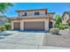 Charming two-story home featuring a three car garage, desert landscaping, and a beautiful tile roof at 15953 W Custer Ln, Surprise, AZ 85379