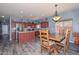Spacious eat-in kitchen featuring stainless steel appliances, a kitchen island, and durable luxury vinyl flooring at 15953 W Custer Ln, Surprise, AZ 85379