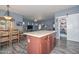 Open-concept kitchen with an island, seamlessly connected to the dining and living areas at 15953 W Custer Ln, Surprise, AZ 85379