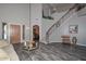 Spacious foyer featuring hardwood floors, a staircase, and ample natural light, perfect for gatherings at 15953 W Custer Ln, Surprise, AZ 85379
