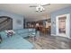 Open-concept living room seamlessly connects to the kitchen, featuring recessed lighting and luxury vinyl plank flooring at 15953 W Custer Ln, Surprise, AZ 85379