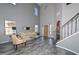 Elegant living room featuring soaring ceilings, abundant natural light, and luxury vinyl flooring at 15953 W Custer Ln, Surprise, AZ 85379