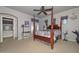 Main bedroom suite with a four-poster bed, chandelier, and access to an ensuite bathroom at 15953 W Custer Ln, Surprise, AZ 85379