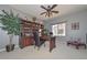 Home office with built-in shelving, a desk, a ceiling fan, and large windows for natural light at 15953 W Custer Ln, Surprise, AZ 85379
