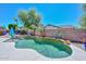 Backyard pool featuring a waterfall and desert landscaping, ideal for relaxation and entertainment at 15953 W Custer Ln, Surprise, AZ 85379