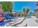 Beautiful backyard pool and spa with comfortable seating, lush landscaping, and a serene ambiance at 15953 W Custer Ln, Surprise, AZ 85379