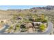 Stunning aerial view of a luxury home nestled in the desert landscape with mountain views at 1607 W Pearce Rd, Phoenix, AZ 85041