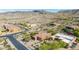 A high-angle view of a desert home surrounded by mature trees and a scenic neighborhood at 1607 W Pearce Rd, Phoenix, AZ 85041