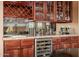 Beautiful bar area with rich wood cabinetry, a wine refrigerator, and glass storage at 1607 W Pearce Rd, Phoenix, AZ 85041