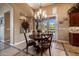 Cozy dining room with a round table, chandelier, and view to the outdoor space at 1607 W Pearce Rd, Phoenix, AZ 85041