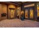 Elegant entryway showcasing custom iron doors, paver flooring, and designer details that create a grand entrance at 1607 W Pearce Rd, Phoenix, AZ 85041