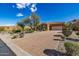 Well-maintained desert home featuring a paver driveway, desert landscaping and an attached two-car garage at 1607 W Pearce Rd, Phoenix, AZ 85041