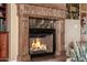 Close-up of a decorative fireplace with a detailed mantel and stone accents at 1607 W Pearce Rd, Phoenix, AZ 85041