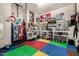 Full view of the home gym setup with colorful floor mats and various workout equipment and accessories at 1607 W Pearce Rd, Phoenix, AZ 85041