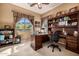 Inviting home office featuring a large desk, built-in bookshelves, and a window with mountain views at 1607 W Pearce Rd, Phoenix, AZ 85041
