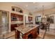 Spacious kitchen island with granite countertop and sink, seamlessly connects to the dining area at 1607 W Pearce Rd, Phoenix, AZ 85041