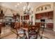 Open-concept kitchen with a central island, dining table, and custom cabinetry at 1607 W Pearce Rd, Phoenix, AZ 85041