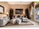 Comfortable living room featuring plush sofas, accent pillows, decorative shelving, and natural light at 1607 W Pearce Rd, Phoenix, AZ 85041