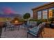 Inviting outdoor patio with comfortable seating around a cozy fireplace for relaxing desert evenings at 1607 W Pearce Rd, Phoenix, AZ 85041